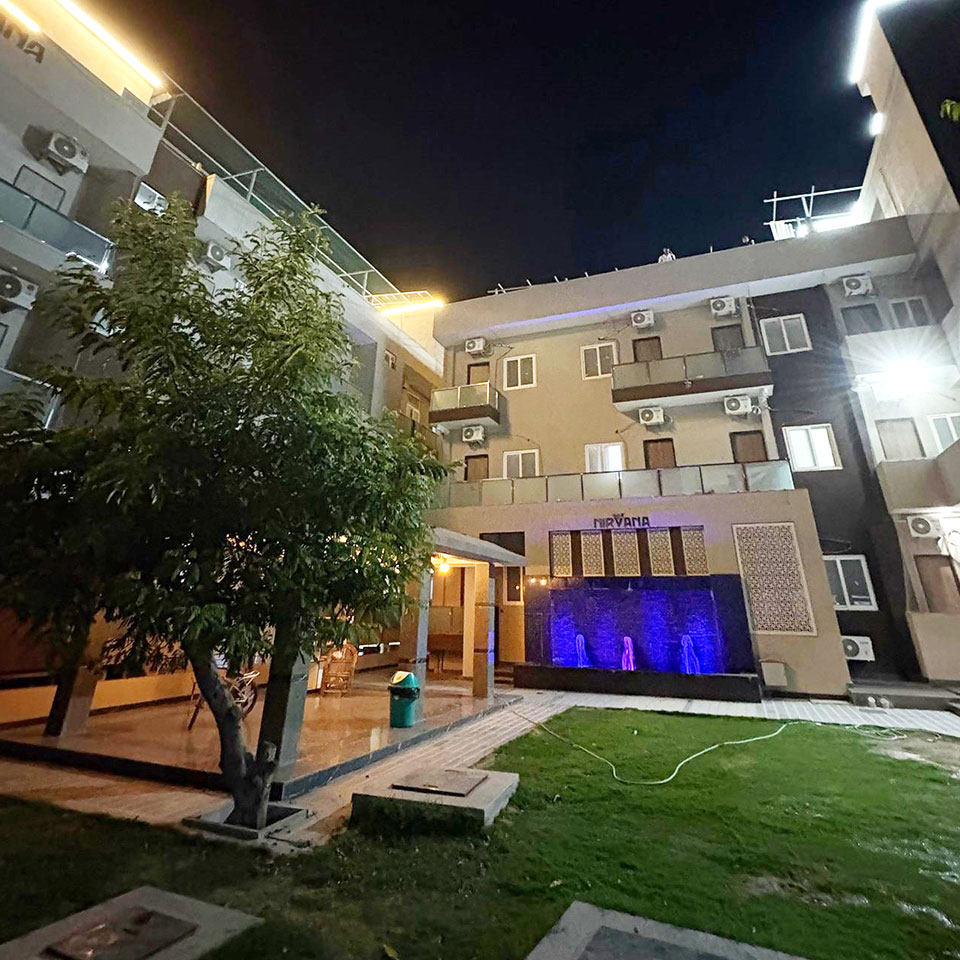 Nirvana Village — the residence and courtyard illuminated at night